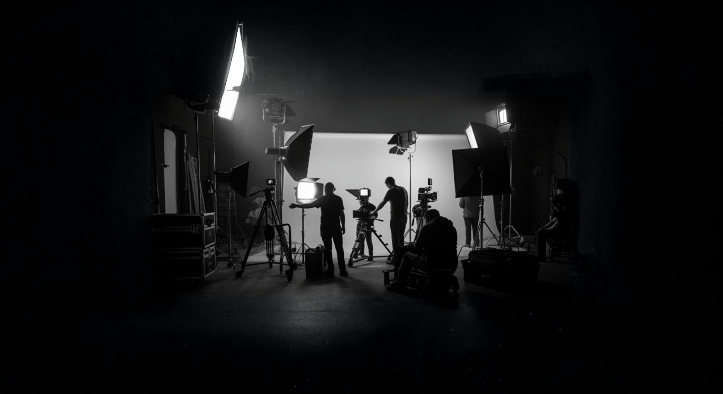A film crew at work on a lit studio set